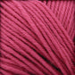 Close-up image of Cascade 220 Superwash Wool Yarn by Cascade Yarns, crafted from 100% merino wool. The bright pink strands are neatly twisted and intertwined, showcasing the vibrant color and beautiful stitch definition of this superwash DK weight yarn.