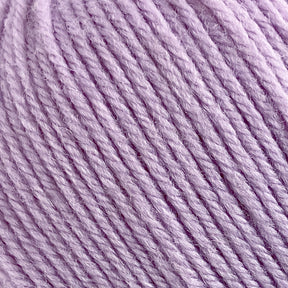 Close-up of a lavender-colored ball of Cascade 220 Superwash Wool Yarn by Cascade Yarns, showcasing its soft, slightly fuzzy texture and neatly wound strands. The 100% merino wool appears to be of medium weight and has a gentle sheen, highlighting the individual fibers for beautiful stitch definition.