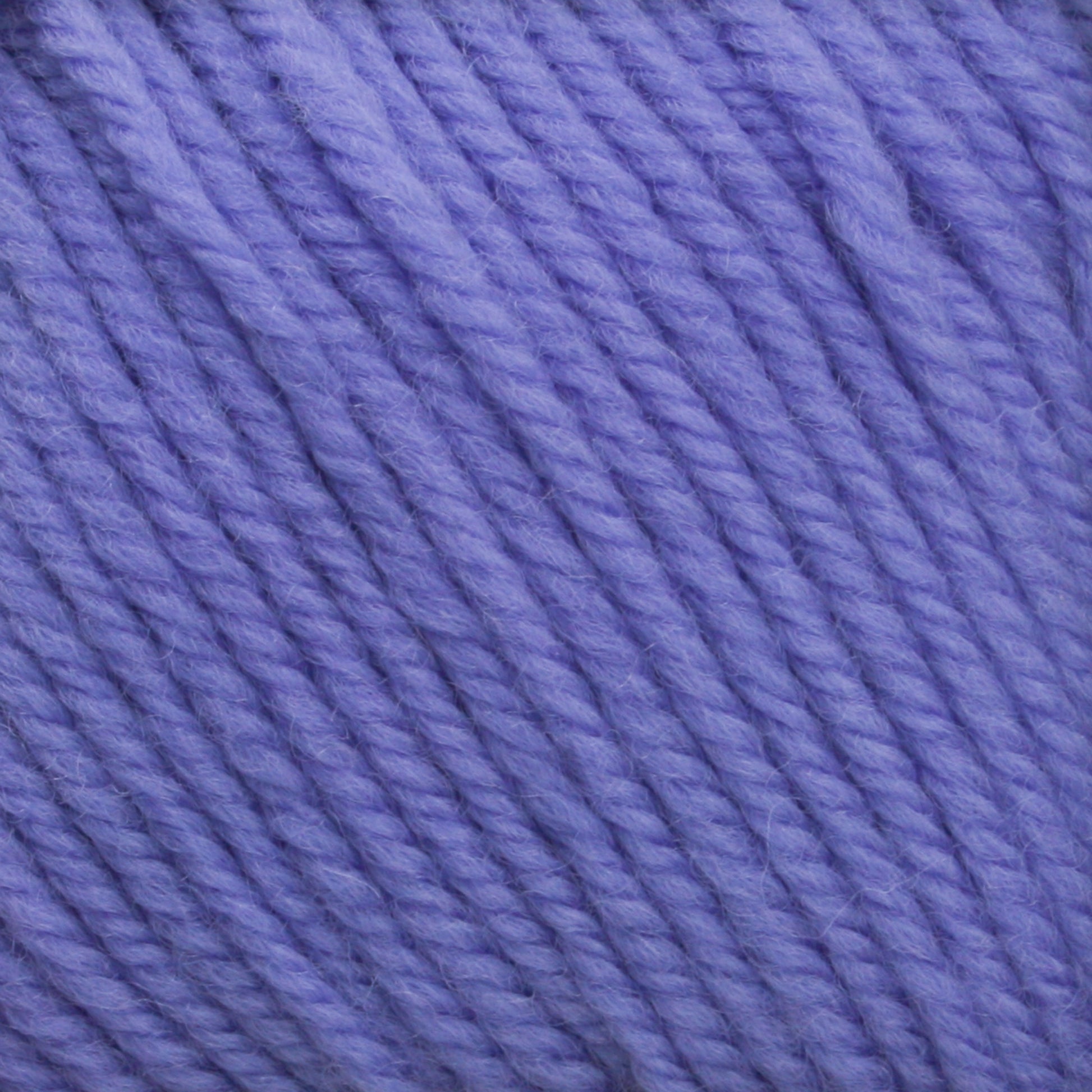 Close-up image of a ball of Cascade 220 Superwash Wool Yarn by Cascade Yarns in DK weight. The tightly wound fibers showcase the texture and slight fuzziness, with individual strands spiraling around each other, offering beautiful stitch definition.