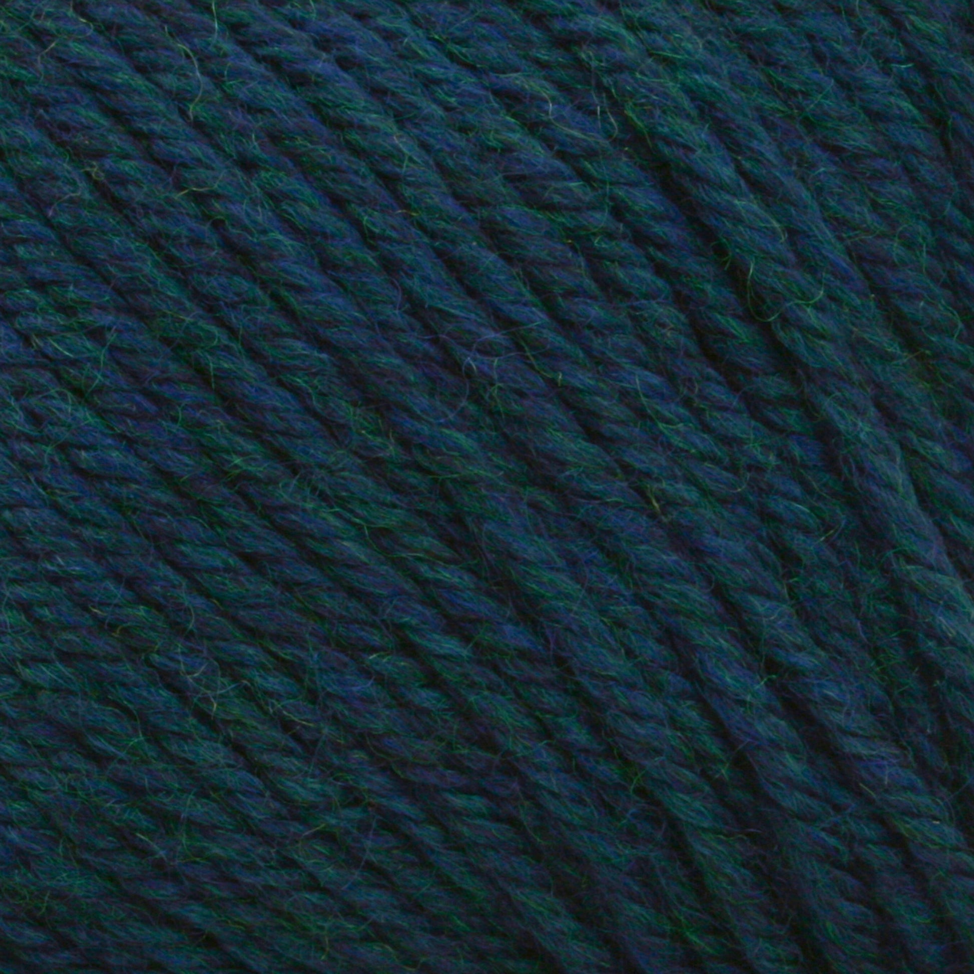 Close-up image of twisted yarn strands in rich blue and green hues, showcasing the detailed texture and beautiful stitch definition. The fibers are interlaced, creating a dense and cozy appearance typical of Cascade 220 Superwash Wool Yarn from Cascade Yarns, made from 100% merino wool in DK weight.