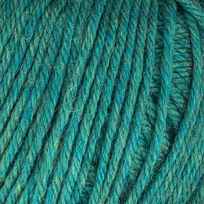 Close-up view of Cascade 220 Superwash Wool Yarn by Cascade Yarns in teal, showcasing tightly wound fibers and a soft, textured appearance. Made from 100% merino wool, the yarn boasts beautiful stitch definition and a mix of blue and green hues, giving it a vibrant yet soothing color palette.