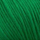 A close-up image of Cascade Yarns' Cascade 220 Superwash Wool Yarn in green, made from 100% merino wool. The yarn is tightly wound and highlights the texture of the fibers, which appear soft and slightly fuzzy. The strands are neatly arranged in parallel lines, showcasing the detailed twists and beautiful stitch definition of this superwash DK weight yarn.