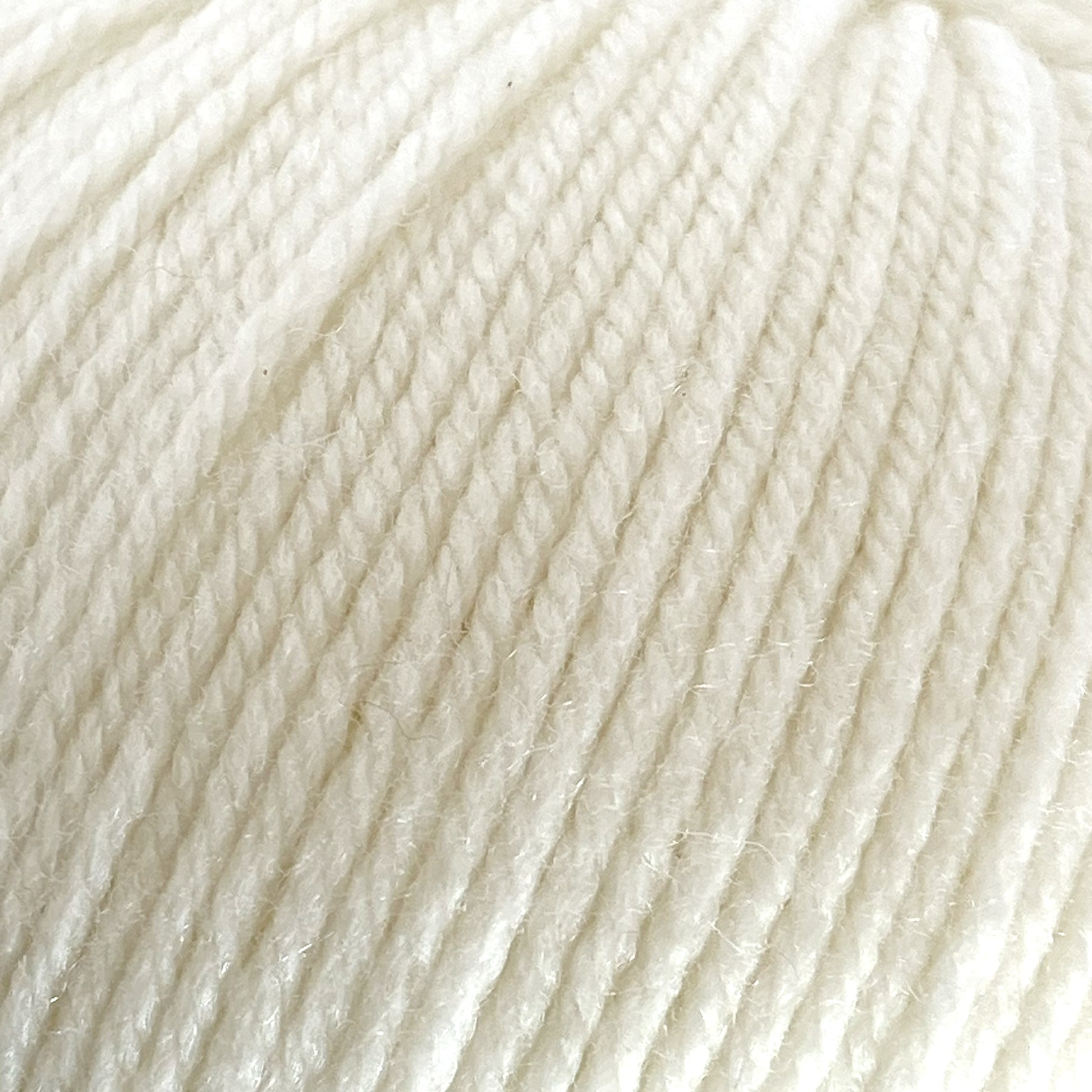 Close-up image of a ball of Cascade 220 Superwash Wool Yarn by Cascade Yarns, highlighting the soft, woven fibers and texture. The 100% merino wool yarn is neatly twisted and appears smooth and fluffy, with beautiful stitch definition indicating it's suitable for knitting or crocheting projects.