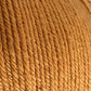 Close-up image of a ball of light brown Cascade 220 Superwash Wool Yarn by Cascade Yarns. The slightly coarse texture with visible individual strands twisted together showcases a beautiful stitch definition. The color is uniform throughout, and some fibers are gently sticking out from the surface, highlighting the quality of this 100% merino wool yarn.