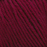 Close-up of Cascade 220 Superwash Wool Yarn in burgundy, showcasing its twist and texture. The rich, deep red 100% merino wool fibers are tightly wound, highlighting the intricate details and beautiful stitch definition. The yarn appears soft and thick, suitable for knitting or crocheting.