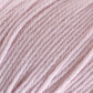 Close-up image of soft, light pink Cascade 220 Superwash Wool Yarn from Cascade Yarns, showcasing its textured, twisted strands. This 100% merino wool yarn appears thick and cozy, suitable for knitting or crocheting with beautiful stitch definition.