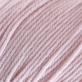 Close-up image of soft, light pink Cascade 220 Superwash Wool Yarn from Cascade Yarns, showcasing its textured, twisted strands. This 100% merino wool yarn appears thick and cozy, suitable for knitting or crocheting with beautiful stitch definition.