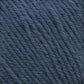 Close-up of Cascade 220 Superwash Wool Yarn in deep blue from Cascade Yarns. The image showcases tightly spun fibers, emphasizing the texture and slight fuzziness of the 100% merino wool material. The uniformly thick and even strands form a coiled pattern, ensuring beautiful stitch definition.