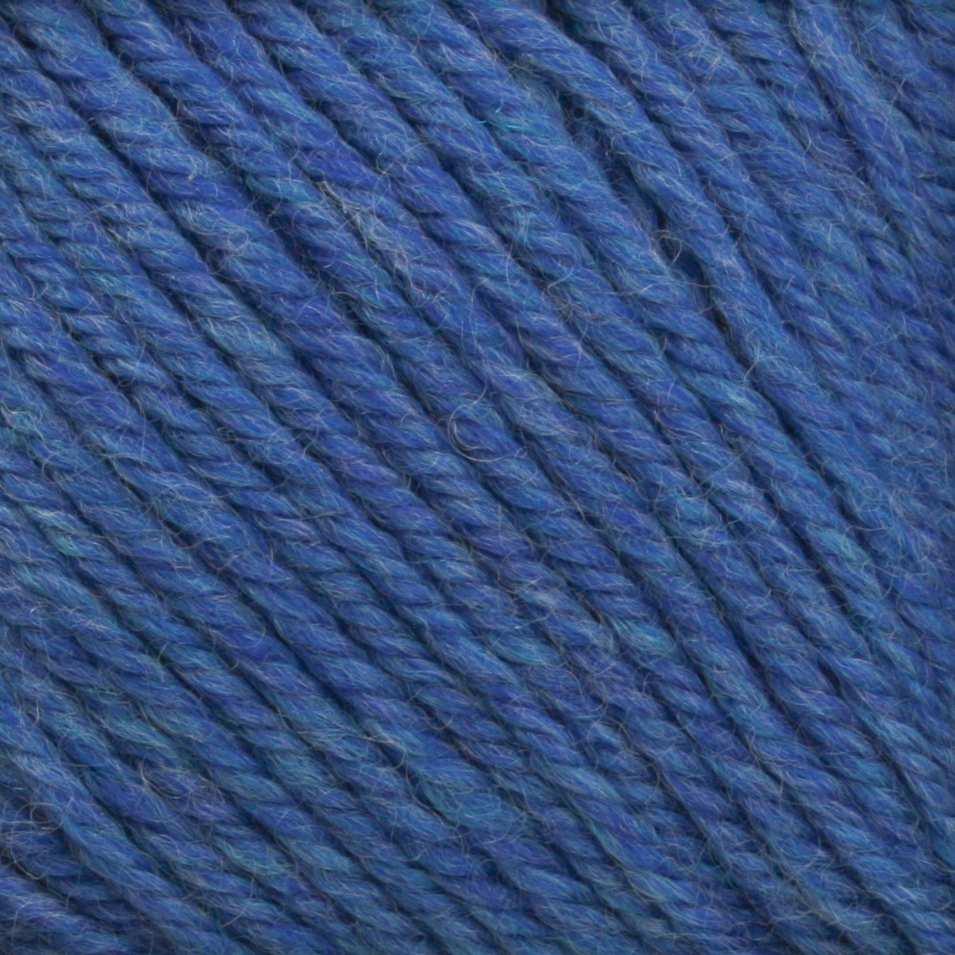 A close-up view of Cascade Yarns' Cascade 220 Superwash Wool Yarn, showcasing its tightly twisted strands and soft, woolen texture. Made from 100% merino wool, the yarn has subtle variations in shades of blue, giving it a rich, multi-dimensional appearance and beautiful stitch definition.