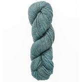 A close-up of a skein of Tundra by The Fibre Co. (UK) Ltd, showcasing the teal hue twisted neatly. This bulky 2-ply yarn looks thick and textured, displaying subtle shading variations against a plain white backdrop.