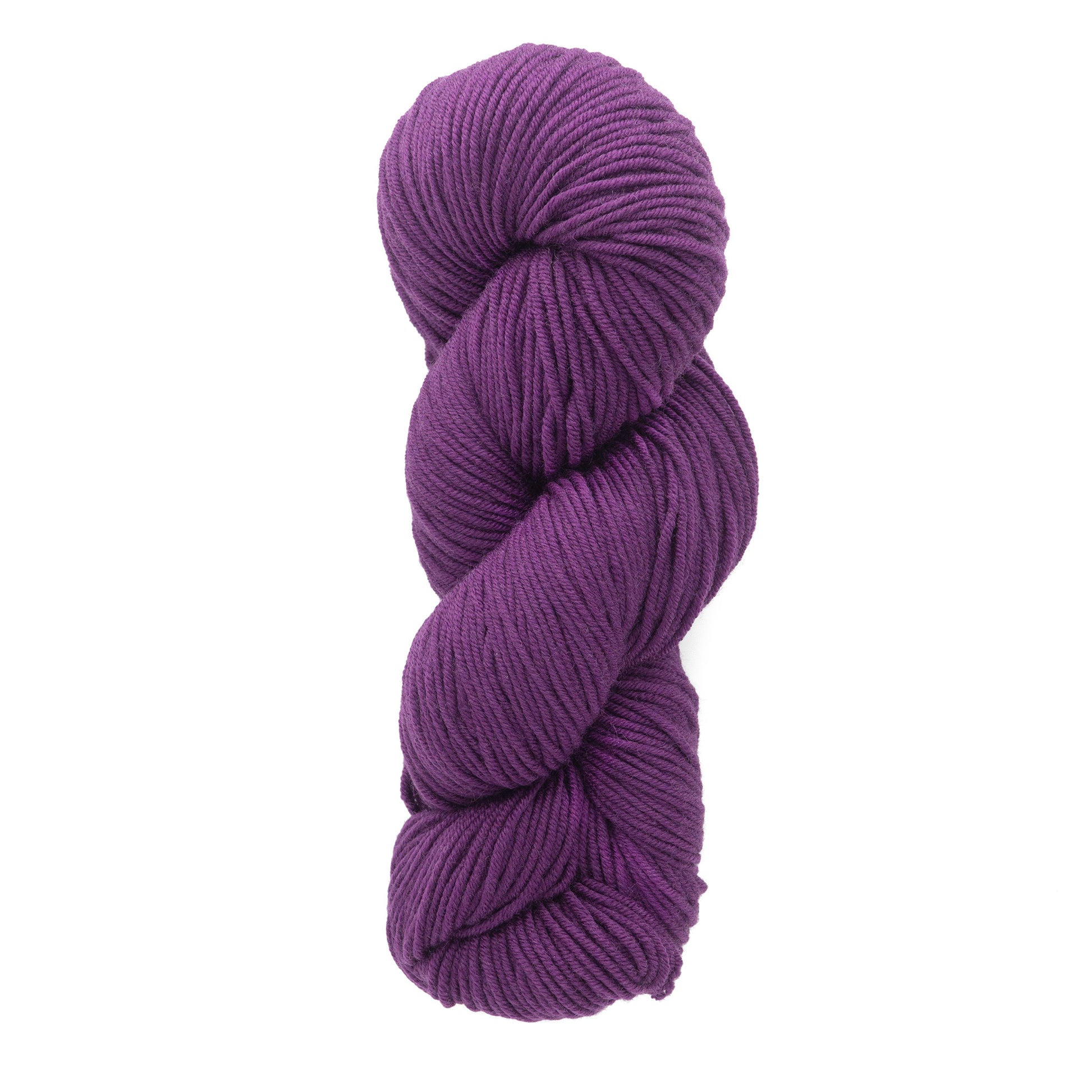 A skein of Plymouth Select Worsted Merino Superwash from Plymouth Yarn Co., in a deep purple shade renowned for its excellent stitch definition, is neatly twisted into an oblong shape against a white background.