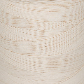 Close-up of a large spool of natural white 20/6 Linen Rug Lacing by Stuart C. Hurlbert & Co., wound tightly in a diagonal pattern. The texture and fine strands of the lacing are clearly visible, giving an impression of its smoothness and durability, perfect for creating braided rugs.