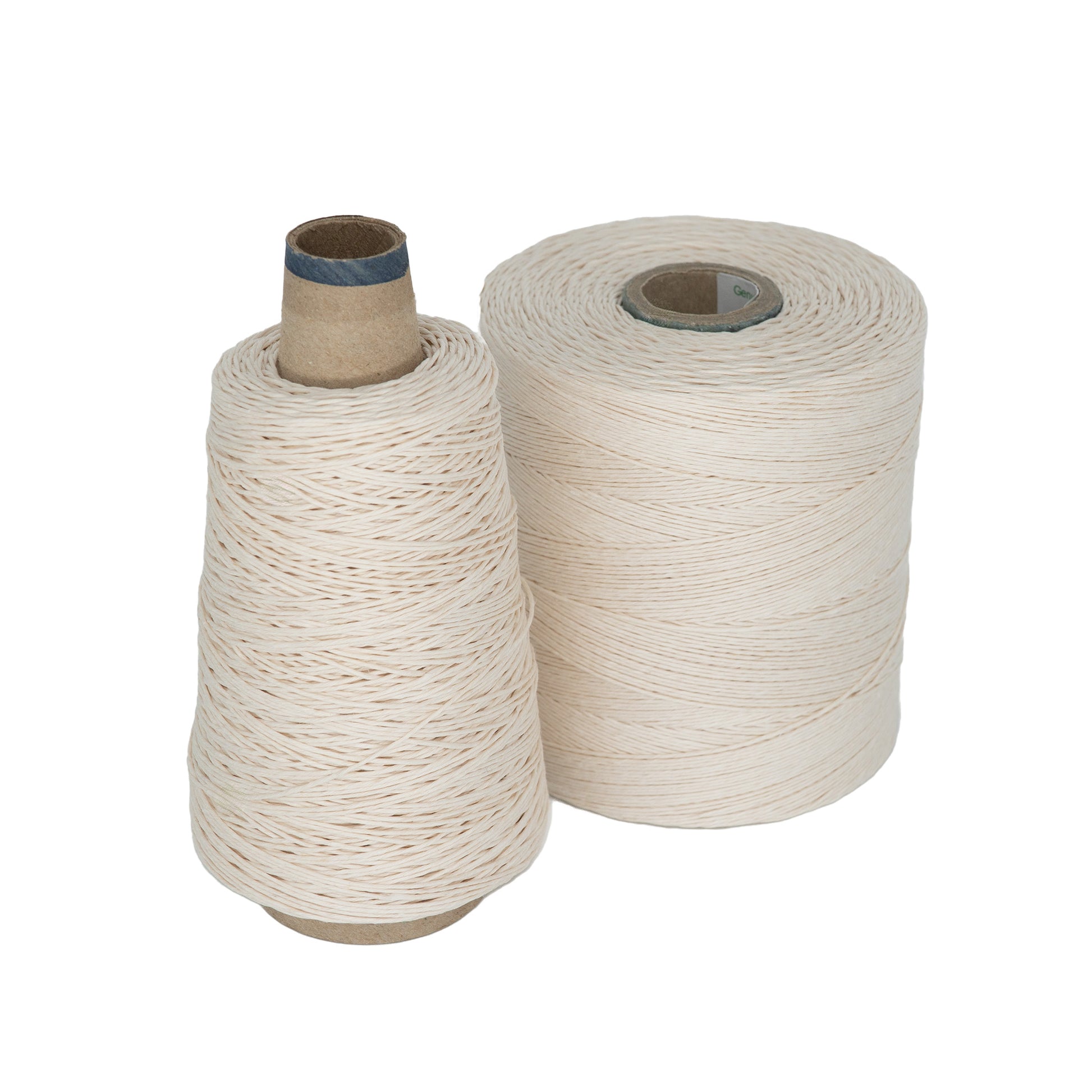 Two spools of natural white twine from Stuart C. Hurlbert & Co. are displayed against a white backdrop. One spool is cone-shaped, while the other is tube-shaped. These 20/6 Linen Rug Lacings are perfect for braided rugs and appear tightly wound, offering reliable strength ideal for crafting durable designs.