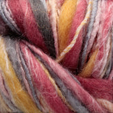 Close-up of textured, multicolored yarn in shades of pink, yellow, gray, and white. The image showcases the fibers interwoven with Universal Yarns' Bamboo Bloom Handpaints, creating a soft and fluffy appearance.