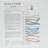 Image shows a Halcyon Yarn Brown Sheep Cotton Fleece Sample Card with attached yarn samples, each in a different color. The card provides details about the 128 Cotton Fleece and 129 Cotton Fine yarns, both cotton blends perfect for warm weather projects. It includes their composition, care instructions, and a color number chart.