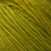 Close-up of a ball of yellow-green Malabrigo Merino Worsted Wool Yarn by Malabrigo Yarn, featuring tightly woven strands with slight flecks of darker yellow-green. The texture appears soft and slightly fuzzy, ideal for knitting or crocheting projects. This worsted weight gauge yarn is perfect for cozy garments and accessories.