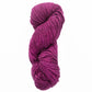 A skein of Malabrigo Merino Worsted Wool Yarn from Malabrigo Yarn, in a rich magenta color, is coiled into a large, twisted bundle against a white background. The kettle-dyed texture looks soft with densely packed strands, ideal for projects needing a worsted weight gauge.