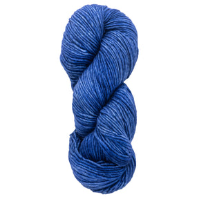 A skein of Malabrigo Merino Worsted Wool Yarn, in a deep blue kettle-dyed color, is twisted into an oval shape. This soft, slightly glossy yarn from Malabrigo Yarn is ideal for knitting or crocheting projects and comes in a versatile worsted weight.