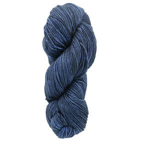 A skein of Malabrigo Yarn's Merino Worsted Wool in a rich, deep blue kettle-dye, expertly coiled in a compact spiral.