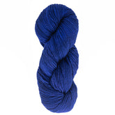 A skein of Malabrigo Merino Worsted Wool Yarn by Malabrigo Yarn, coiled neatly with a soft texture and rich dark blue color. The worsted weight yarn is tightly twisted, giving it a smooth appearance against a plain white background.