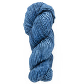 A skein of thick, textured Malabrigo Merino Worsted Wool Yarn by Malabrigo Yarn in shades of blue, neatly coiled and isolated on a plain white background.