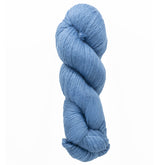 A twisted hank of Cumulus Cotton by Juniper Moon Farm, a light blue yarn from Knitting Fever/Euro Yarns, rests against a white background. This soft, durable cotton is ideal for knitting or crocheting sweaters and scarves with its smooth texture.