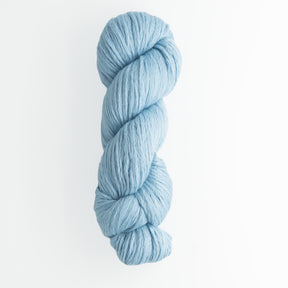 A skein of Cumulus Cotton by Juniper Moon Farm is twisted into a neat hank against a plain white background. The yarn appears soft and woolly, showcasing the quality of durable yarn with a smooth and even texture, brought to you by Knitting Fever / Euro Yarns.