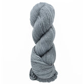 A twisted skein of Cumulus Cotton by Juniper Moon Farm, known for its durability and softness, lies in light gray against a white background. Brand: Knitting Fever / Euro Yarns.