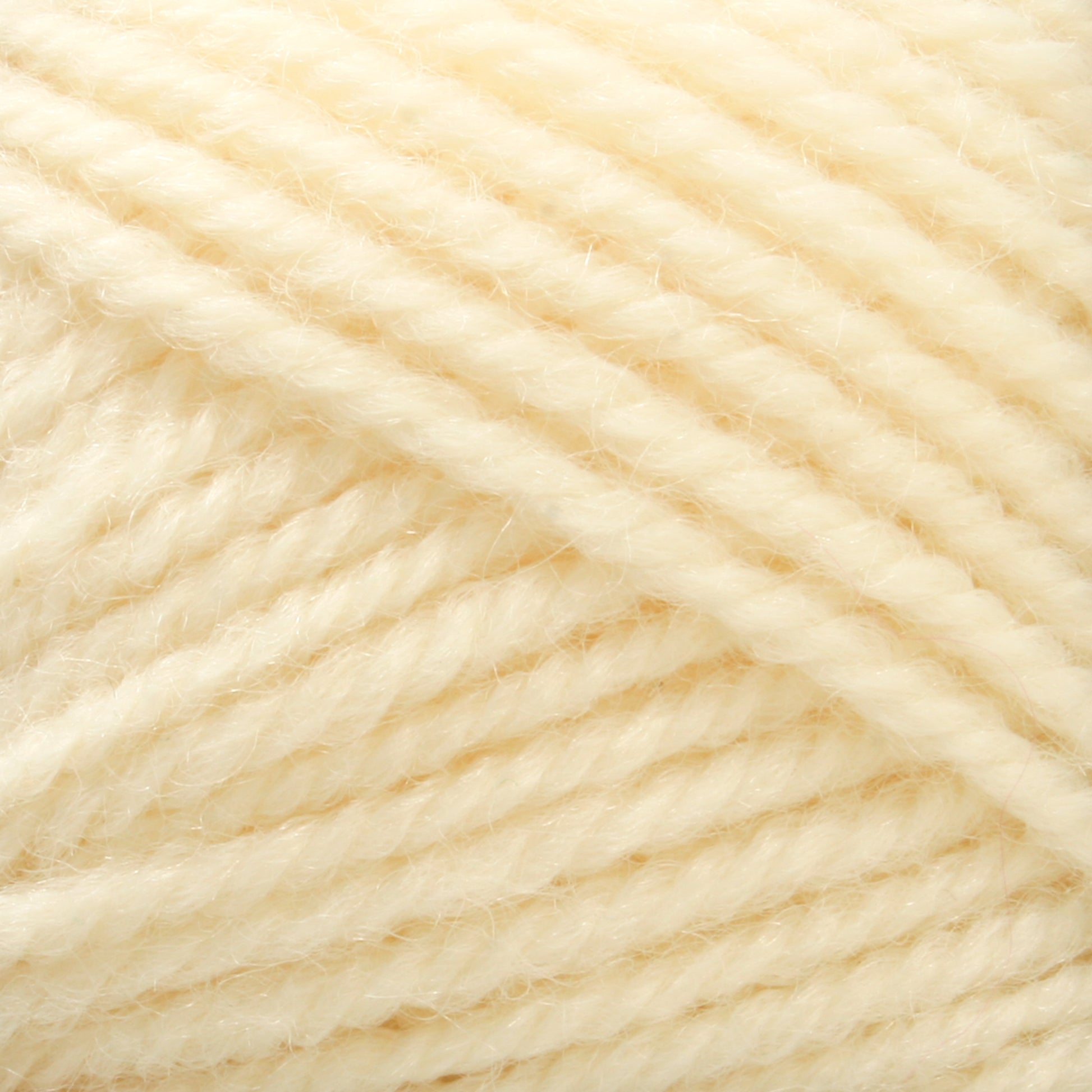 Close-up image of a ball of cream-colored Plymouth Encore Worsted Yarn from Plymouth Yarn Co., featuring a soft texture. This machine washable yarn is tightly wound, with slightly fuzzy fibers that lend it a cozy, warm appearance.