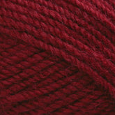 Close-up view of Plymouth Encore Worsted Yarn by Plymouth Yarn Co. in a rich burgundy hue, featuring intricate, tightly woven strands that highlight the machine washable fiber's texture and detail.