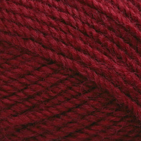 Close-up view of Plymouth Encore Worsted Yarn by Plymouth Yarn Co. in a rich burgundy hue, featuring intricate, tightly woven strands that highlight the machine washable fiber's texture and detail.