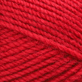 Close-up image of Plymouth Encore Worst Yarn by Plymouth Yarn Co., in red, worsted weight, showcasing the detailed texture of the tightly wound fibers. The yarn appears soft and thick, perfect for knitting or crocheting projects. The vibrant red color is uniform throughout the strands. This economical option is also machine washable for easy care.