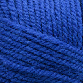 Close-up image of a ball of Plymouth Encore Worsted Yarn by Plymouth Yarn Co., featuring tightly wound, textured fibers in a soft blue color. The yarn appears to be soft, evenly twisted, and an economical option for various projects.