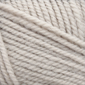 Close-up image of Plymouth Encore Worsted Yarn from Plymouth Yarn Co., coiled in a ball. The off-white yarn's texture is clearly visible, showcasing a soft and slightly fluffy appearance with individual fibers intertwined in a neat and consistent pattern.