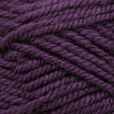 Close-up image of Plymouth Encore Worsted Yarn strands in dark purple, showcasing the texture and thickness of the fibers. The yarn appears soft with some slight fuzziness, highlighting its woolly material. This economical option from Plymouth Yarn Co. is also machine washable, making it both practical and versatile.