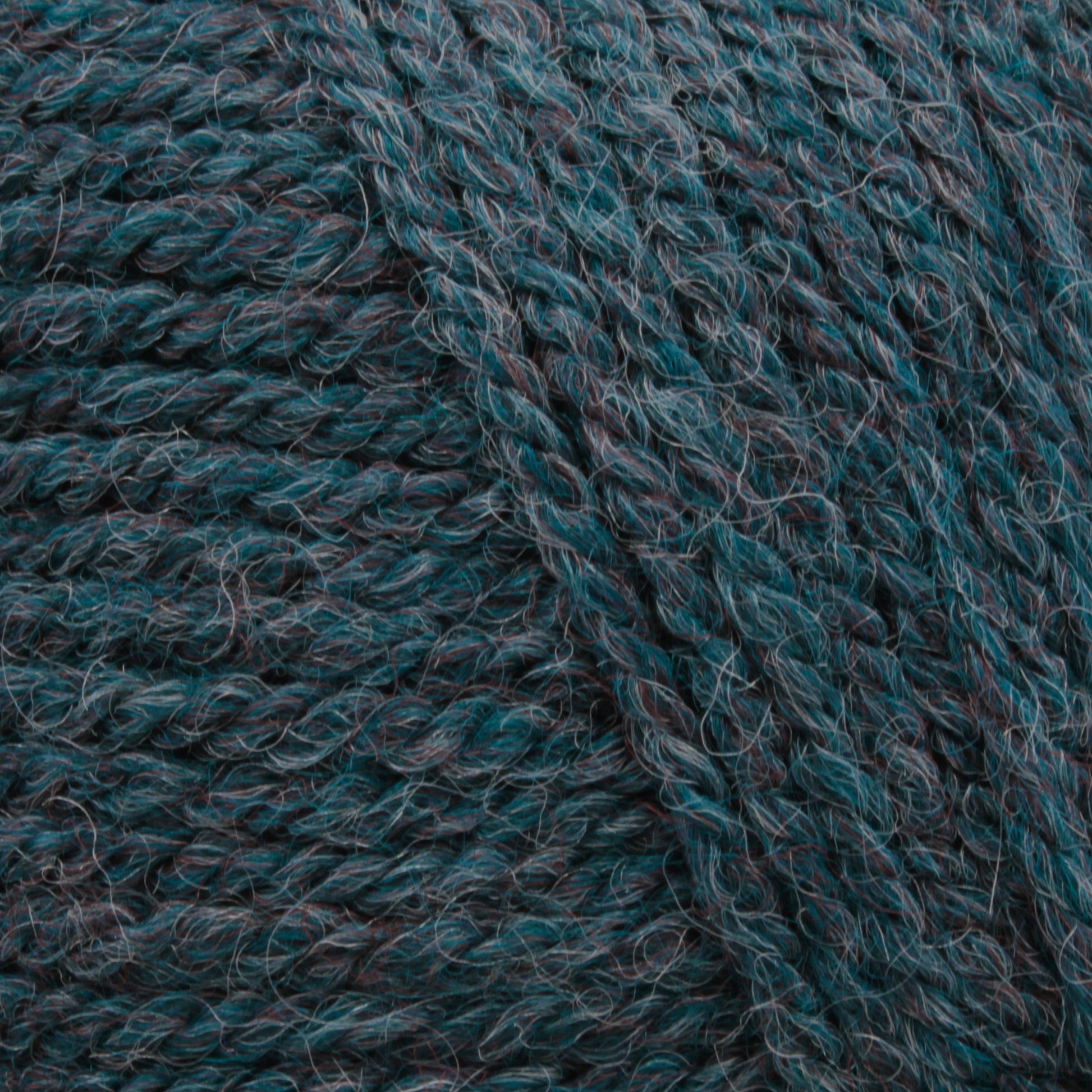 Close-up image of dark green and black Plymouth Encore Worsted Yarn by Plymouth Yarn Co., showing its thick, tightly woven fibers and slightly fuzzy texture. The strands have a natural twist, highlighting the mix of colors and the intricate details of this economical yarn option.