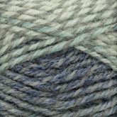 Close-up of a ball of Plymouth Encore Worsted Yarn with varying shades of blue and gray. The fibers are interwoven, creating a textured and cozy appearance. The image highlights the yarn's soft, fuzzy texture, making it ideal for knitting projects and an economical option for crafters from Plymouth Yarn Co.