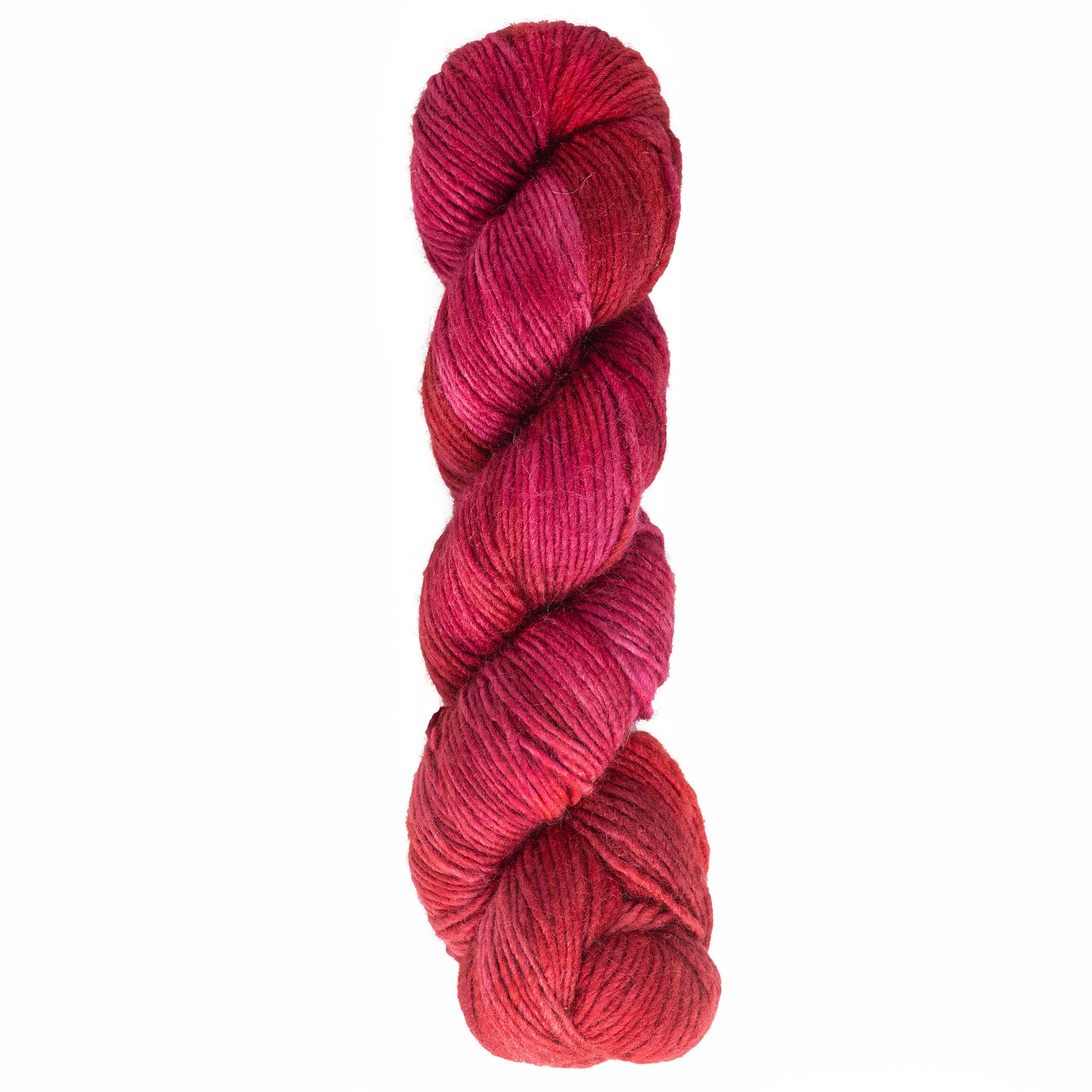 A skein of Malabrigo Silky Merino by Malabrigo Yarn in shades of pink and red, twisted neatly.