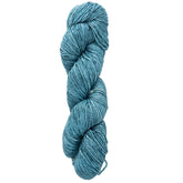 A skein of Malabrigo Silky Merino yarn from Malabrigo Yarn in a luxurious teal hue, carefully twisted to display its soft and textured appearance, set against a white background.