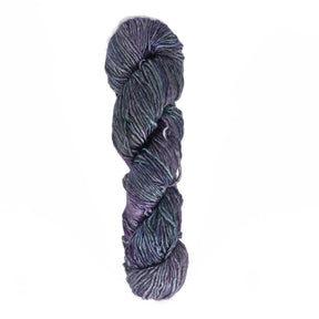 A twisted skein of Malabrigo Yarn's luxury Malabrigo Silky Merino, showcasing hues of purple, blue, and gray against a plain white background. The yarn boasts a smooth texture and a slight sheen, indicating a premium blend of fibers or special treatment for added luster.