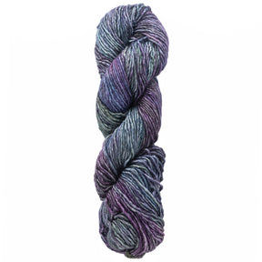 A twisted skein of Malabrigo Yarn's luxurious "Malabrigo Silky Merino" in captivating shades of purple, blue, and green is displayed against a white background. This silk yarn features a thick and textured appearance, beautifully blending the colors in a visually appealing manner.