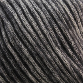 Close-up image of a skein of Katia Cotton-Merino yarn, an aran weight product from Knitting Fever / Euro Yarns, with a striped pattern in various shades of gray. The luxury yarn appears to have a soft and fuzzy texture. The strands are tightly wound together, showcasing the different tones from light to dark gray.