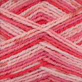 Close-up of pink and red Regia Cotton Tutti Frutti Color sock yarn by Sirdar - Regia, Schachenmayr & Rowan. The self-striping yarn is arranged in a crisscross pattern, showcasing various shades of pink, red, and white interwoven together. The texture appears soft and woolly, capturing the intricate details and breathable quality of the threads.