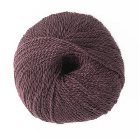 A large round ball of dark purple Jo Sharp Alpaca Kid Lustre yarn from Kingfisher Yarn & Fibre, featuring a textured, slightly twisted strand, neatly wound into a compact shape against a white background. This luxurious blend, ideal for DK gauge patterns, adds an elegant touch to your projects.