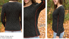 A person outdoors is wearing a dark gray Hearthstone Cabled Pullover from Halcyon Yarn, featuring red accents along the side seams. The sweater boasts a textured diamond cable pattern and is made of DK weight yarn. Three images depict the pullover from the back, side, and front, with autumn leaves covering the ground.