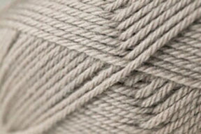 Close-up image of a beige ball of yarn, showcasing its tightly wound strands and smooth texture. This Jo Sharp Classic DK Wool by Kingfisher Yarn & Fibre exemplifies the versatility and quality associated with premium grade wool.