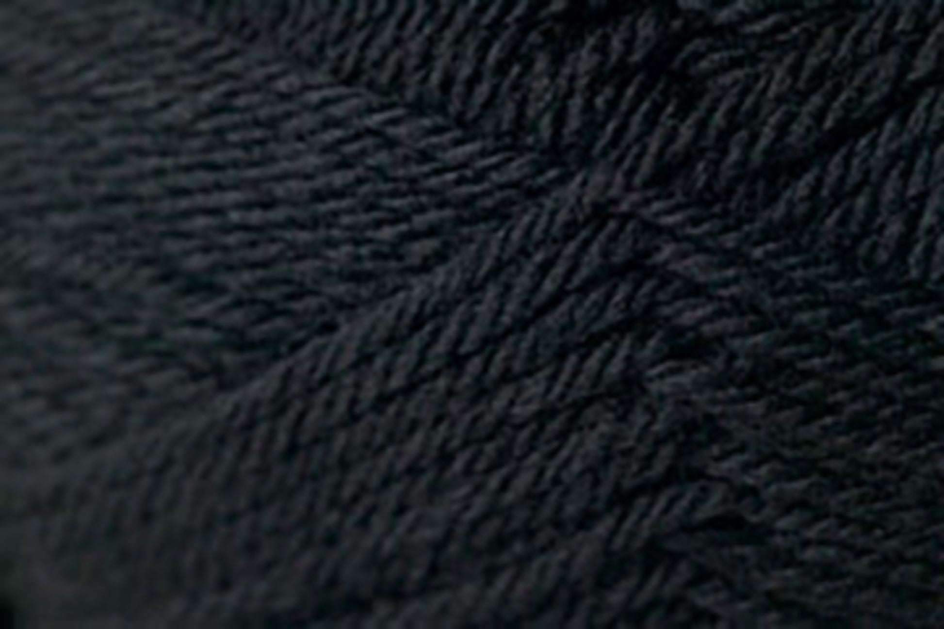 Close-up image of a spool of Jo Sharp Classic DK Wool by Kingfisher Yarn & Fibre. The tightly twisted strands create a textured pattern in the fabric, revealing a rich, uniform color and a soft, pliable surface—a perfect example of versatile DK gauge premium grade wool.