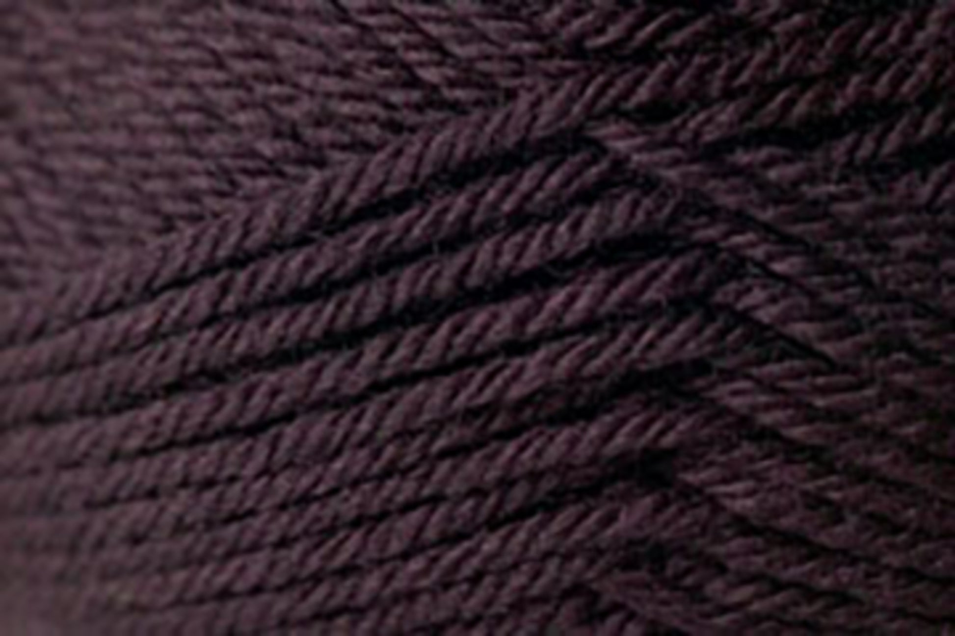 Close-up image of tightly wound, dark brown yarn. The texture of Kingfisher Yarn & Fibre's premium grade Jo Sharp Classic DK Wool is clearly visible, demonstrating the individual strands and the slight variations in color within the fibers. This versatile DK gauge yarn is arranged in a diagonal layering pattern.