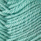 A close-up view of soft, teal-colored yarn made from Jo Sharp Classic DK Wool by Kingfisher Yarn & Fibre. The yarn is tightly wound, showcasing a slightly fuzzy texture and twisted strands. The vibrant color and detailed texture are the main focal points of the image.