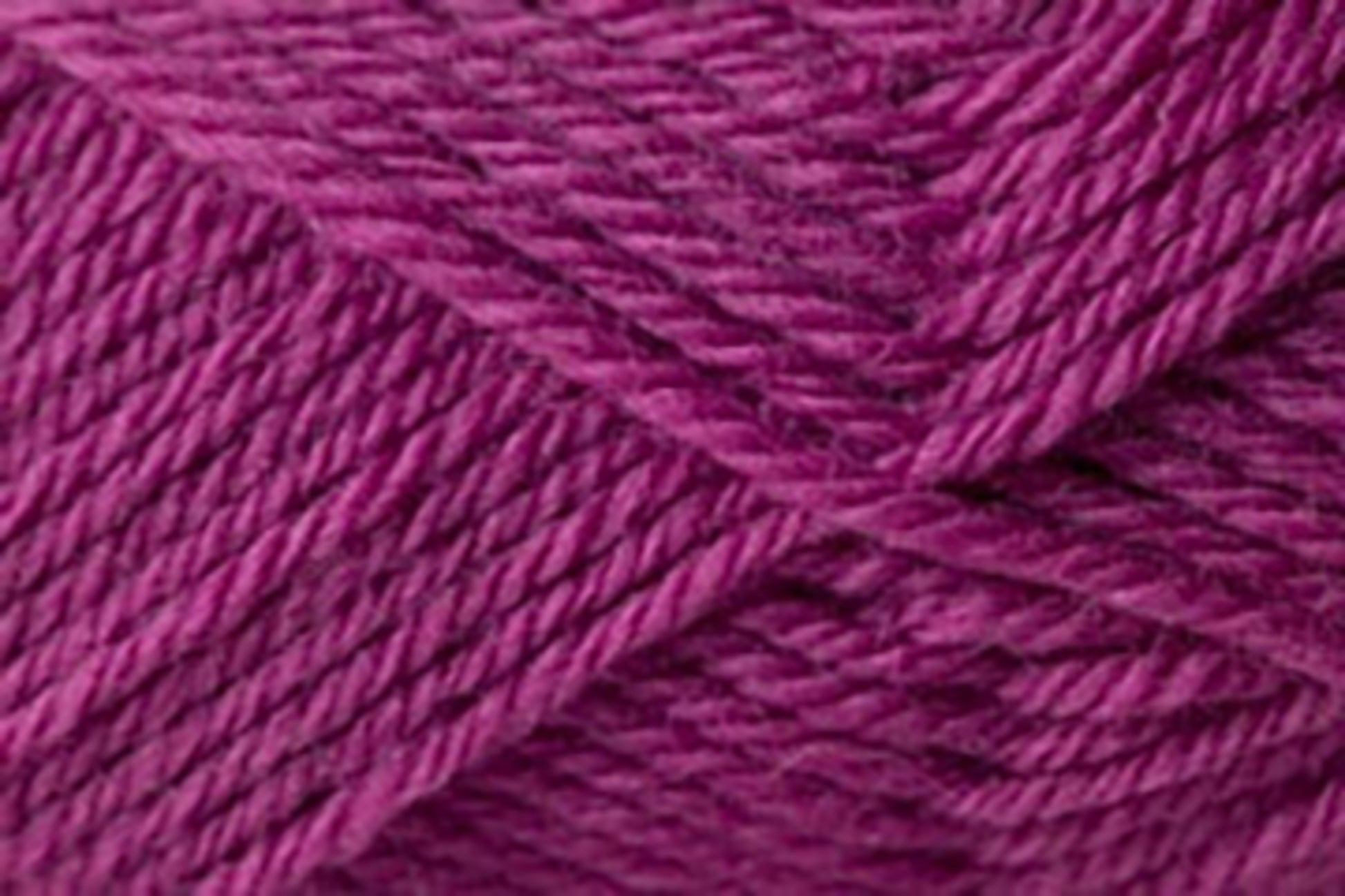 Close-up of purple Jo Sharp Classic DK Wool strands wound in a criss-cross pattern, creating a textured and dynamic appearance. The yarn fibers from Kingfisher Yarn & Fibre are tightly twisted, giving it a smooth yet detailed look, suitable for knitting or crochet projects.